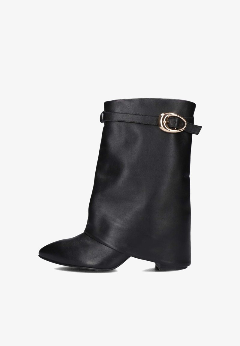 Zwarte leren enkelboot met een spitse neus en een brede, slungelige schacht. Voorzien van een dunne riem met een gouden ovale gesp bij de enkel.