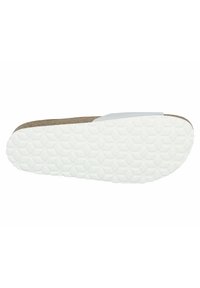 Cork and white rubber sandal sole, featuring a textured hexagonal pattern for traction. Flat profile with a curved edge.