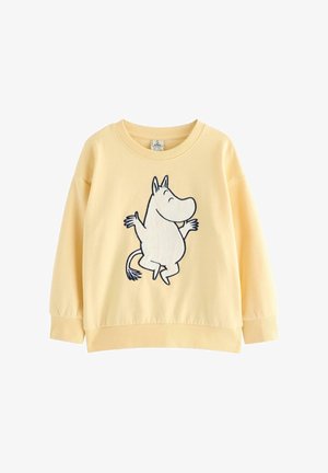 Gul sweatshirt med ribbede manchetter og kant, der har en brodering af en Mumi-figur i sort og hvid på forsiden. Blød stoftekstur.