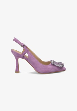 Purple suede slingback pump with a pointed toe, adorned with a jeweled embellishment, and a thin heel. Adjustable strap with a metal buckle.