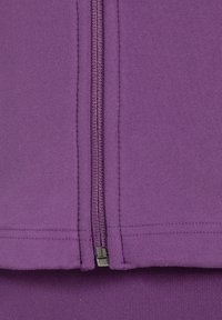Purple zip-up jacket with a smooth texture, featuring a prominent zipper at the center and stitched detailing along the seams.