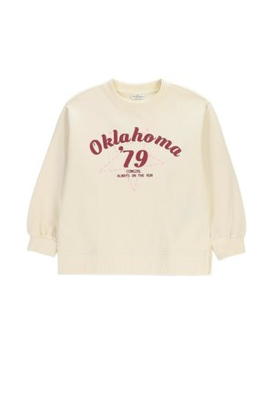 Bluza w kolorze kremowym z bordowym napisem "Oklahoma '79" oraz mniejszym tekstem "Cowgirl Always on the Run" na tle delikatnego różowego konturu gwiazdy.