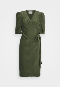 Olive green wrap dress made of textured fabric, featuring short puff sleeves, a tie at the waist, and a knee-length hem.