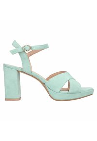 Mintgroene suède hoge hakken sandaal met een blokhak, gekruiste banden, een ronde accent en een open teendesign.