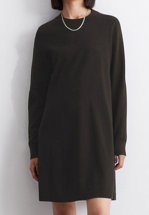 Dark green long-sleeve dress with crew neckline, made from soft fabric. Features a straight cut and side slits for ease of movement.