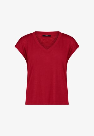 Haut rouge pour femme à manches courtes et col en V, coupe ample avec une petite étiquette noire à l'intérieur du col.