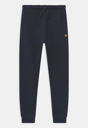 Mørk marineblå smalle sweatpants med elastisk talje, snøre, manchetter ved anklerne og et lille gult ørnelogo på højre hofte.