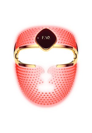 Red silicone facial mask with a textured surface and gold accents, featuring a diamond-shaped control panel in the center.