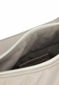 Borsa sintetica grigia chiara con esterno testurizzato, dotata di chiusura con zip e interno foderato in tessuto con un ulteriore tasca.