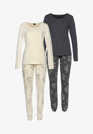 Two sets of loungewear: a cream long-sleeve top with three buttons paired with cream pants featuring a floral pattern; a dark gray top and black pants with similar floral designs.