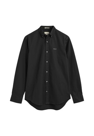 Camisa negra de algodón con botones. Presenta un cuello estándar, mangas largas y un dobladillo curvado. Pequeño logo en la parte izquierda del pecho.