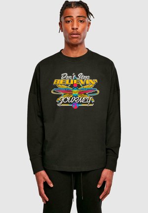 Black long-sleeve shirt featuring a colorful graphic design with "Don't Stop Believin'" text and winged elements. Soft fabric texture.