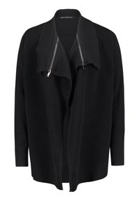 Svart kofta med ribbad textur och bred krage. Har dragkedja framtill, långa ärmar och en öppen silhuett.