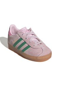 Pink suede sneaker with green stripes, pale pink accents, round toe, and rubber gum sole. Features flat laces and raised brand logo.