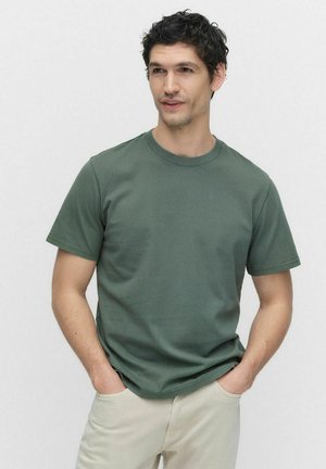 Groene katoenen t-shirt met een ronde halslijn, korte mouwen en een klassieke pasvorm. Getextureerde stof met minimale stikseldetails.