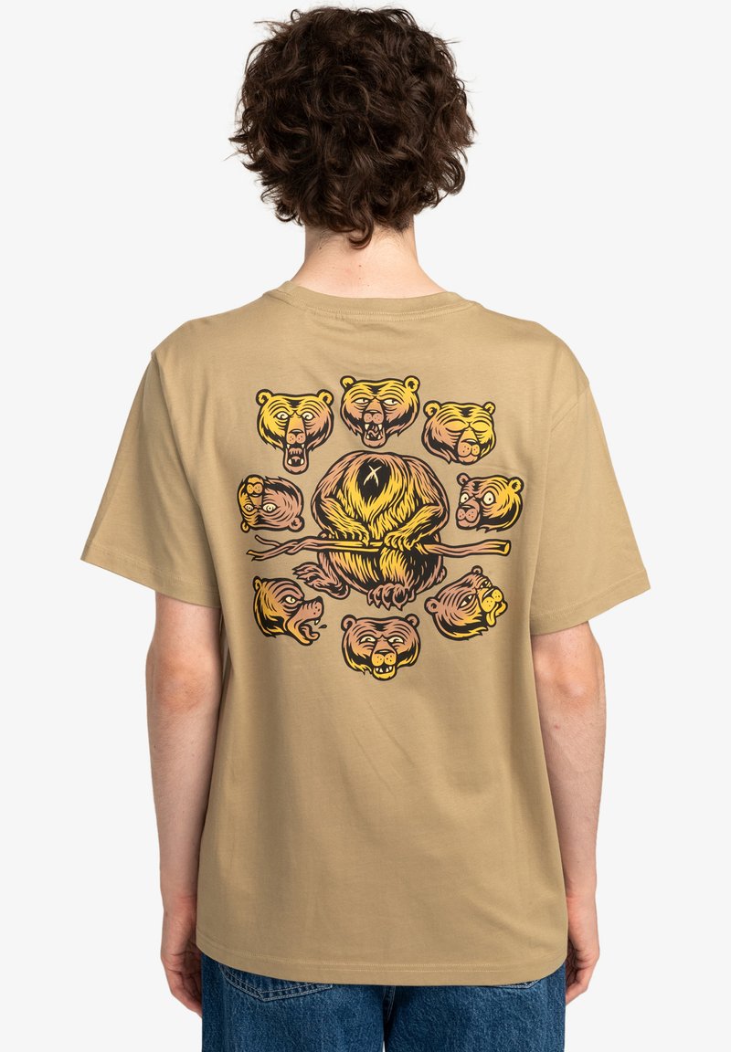 Beige t-shirt featuring a colorful bear graphic design on the back, with various bear faces and a central bear holding a stick.