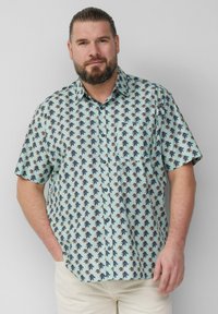 Kurzarmhemd in Hellblau mit Palmbaum-Muster. Verfügt über eine Knopfleiste, Kragen und einen lässigen Schnitt. Hergestellt aus glattem Stoff.