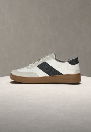 Fehér és szürke sportcipő fekete mintás csíkkal, velúr részletekkel, kerek orral és gumitalppal. "Michael Kors" logó az oldalon.