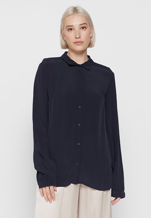 Navy blue long-sleeve blouse with a collared neckline, button front, and relaxed fit. Smooth fabric with slightly gathered cuffs.