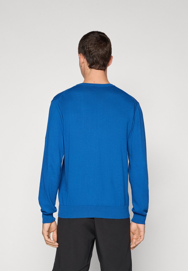 Blauwe pullovertrui met een ronde hals en lange mouwen. Gemaakt van een gestructureerde gebreide stof. Heeft ribgebreide manchetten en een zoom.