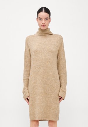 Beige knitted sweater dress with a high turtleneck, loose fit, and extended sleeves, featuring a soft, textured fabric.