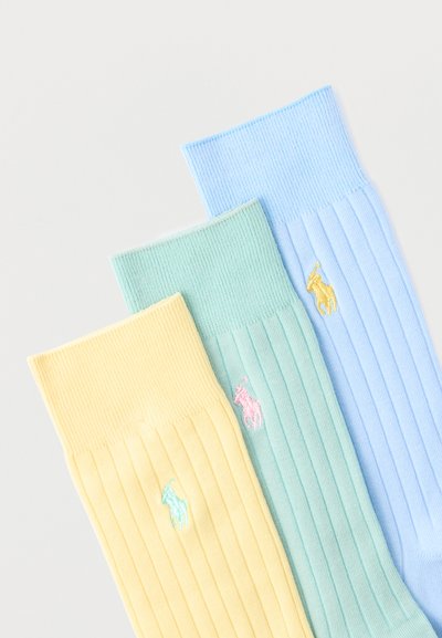 Τρεις ριγωτές κάλτσες σε παστέλ κίτρινο, πράσινο και μπλε, η καθεμία με ένα μικρό κεντημένο λογότυπο αλόγου και αναβάτη σε αντιθετικά χρώματα.