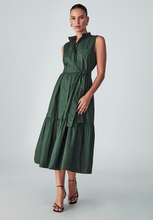 Groene, mouwloze jurk met een kraag, knoopsluiting aan de voorkant en een tailleband. Beschikt over een gelaagd rokdesign en een zachte katoenstructuur.