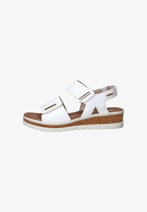 White leather sandal with cork wedge sole, two adjustable straps with gold accents, open toe, and brand logo on heel strap.