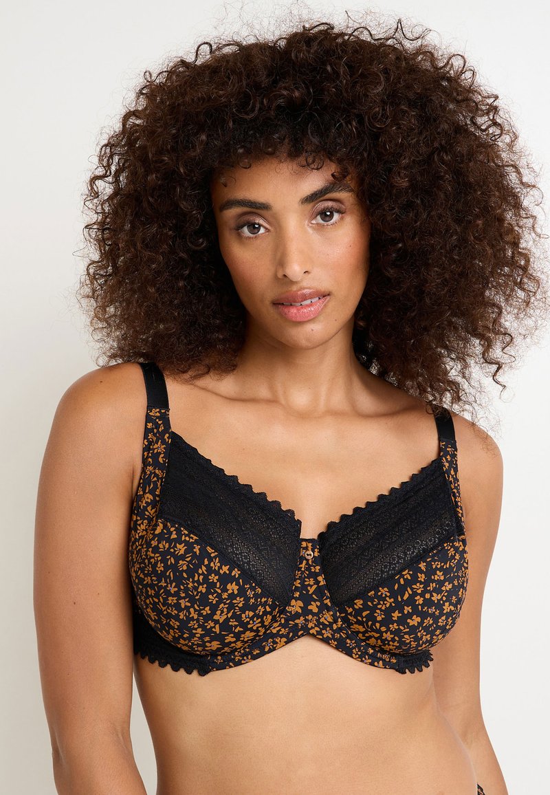 Reggiseno floreale nero e arancione con dettagli in pizzo, bordi a onde e spalline regolabili; presenta un design bicolore con una vestibilità strutturata.