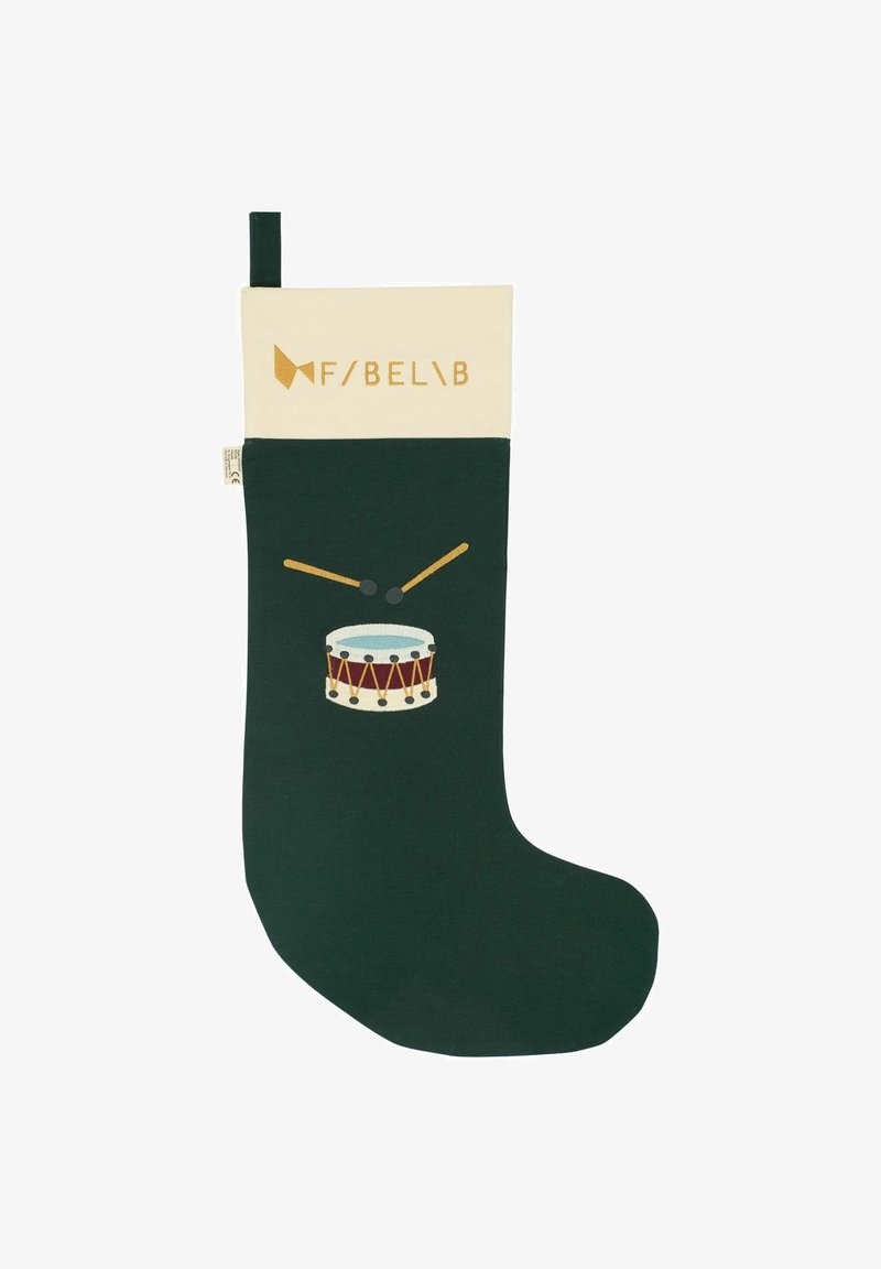 Chaussette de Noël verte en tissu avec un bord crème. Présente une illustration de tambour et un logo de marque doré sur le bord.