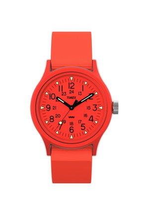 Timex watch with a round red silicone case and strap. Black hour and minute hands, white hour markers, and a date display on a red dial.