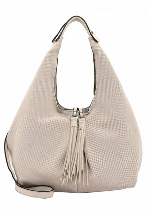 Sac à main en cuir beige perforé de forme hobo, avec deux longues franges et un accent noir autour de l'ouverture.
