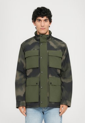 Green and black jacket with a camouflage pattern, high collar, and four large front pockets; made of smooth material. Buttons along the front.