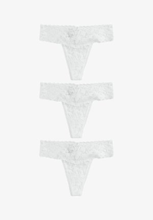 Strings en dentelle blanche avec un motif floral, des bords festonnés et une texture transparente, présentés en ensemble de trois.