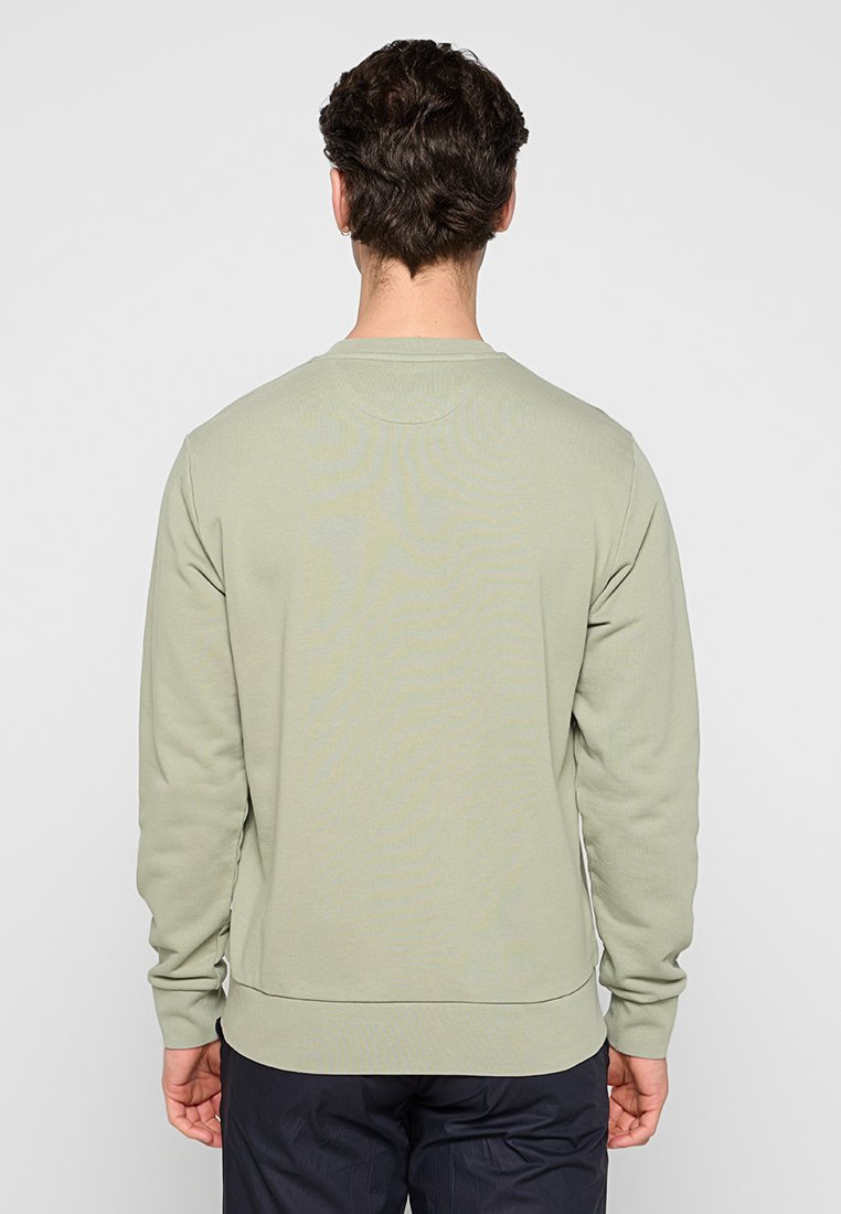 Sweatshirt vert clair à manches longues, avec des poignets côtelés et un col rond. Tissu doux avec une texture lisse et une coupe décontractée.