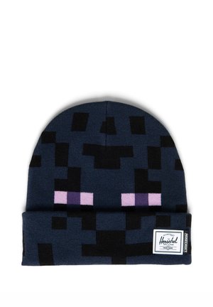 Gorro de punto azul oscuro con patrón pixelado negro y ojos estilo píxel morados, con la etiqueta Herschel y Minecraft en el puño.