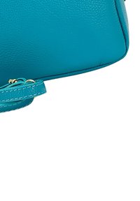 Teal leren handtas met een gestructureerde afwerking, voorzien van een korte strap en een gouden ritsaccent. Afmetingen en sluitdetails niet zichtbaar.