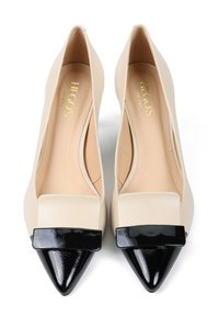 Beżowe szpilki z czarnymi, błyszczącymi, ostro zakończonymi noskami oraz prostokątnymi czarnymi akcentami, z logo "Hego's Milano" wewnątrz.