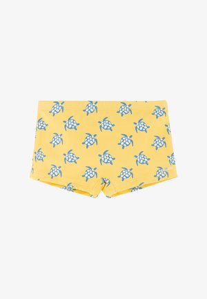 Bañador amarillo con un patrón completo de tortugas marinas azules y blancas, con un diseño ajustado de corte cuadrado.