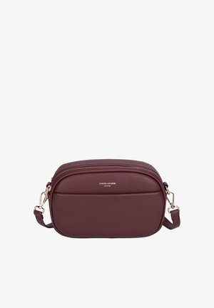 Small burgundy crossbody bag with rounded edges, front pocket, gold zipper, and gold hardware on detachable strap.