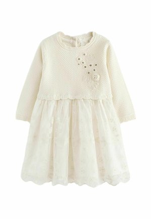 Babykleid in Cremefarbe mit gestricktem Langarm-Oberteil und floralem Spitzenrock, verziert mit kleinen Stoffblumen auf der Brust.