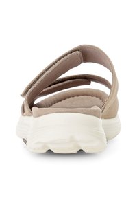Beige sandal with two wide straps and a cushioned footbed. Features a white, textured rubber sole for grip and support.