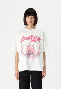White cotton t-shirt with a front graphic featuring a pink circular design and abstract elements; short sleeves and relaxed fit.