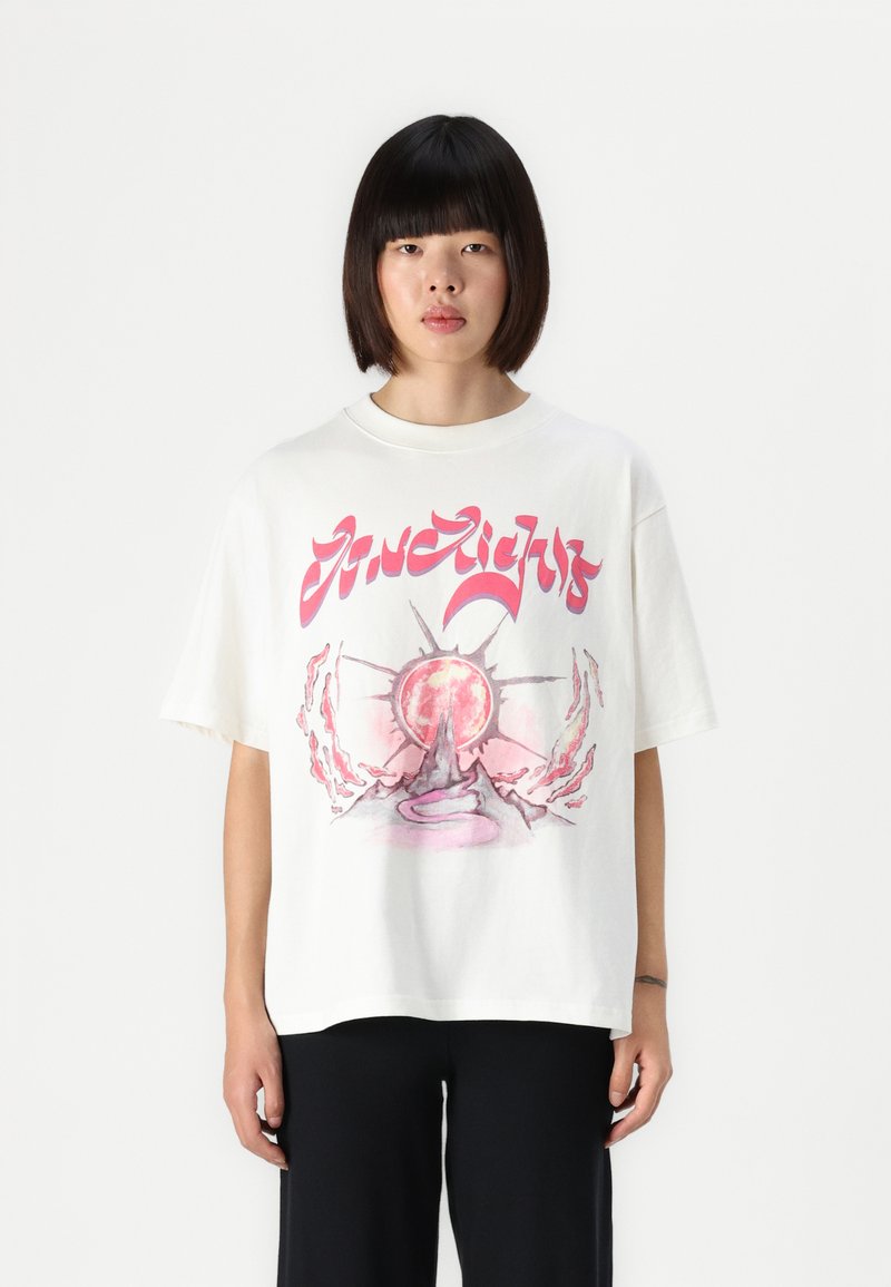 White cotton t-shirt with a front graphic featuring a pink circular design and abstract elements; short sleeves and relaxed fit.