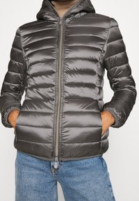 Gray puffer jacket with a hood, featuring a quilted design, zip closure, and two side pockets. Smooth, shiny texture.