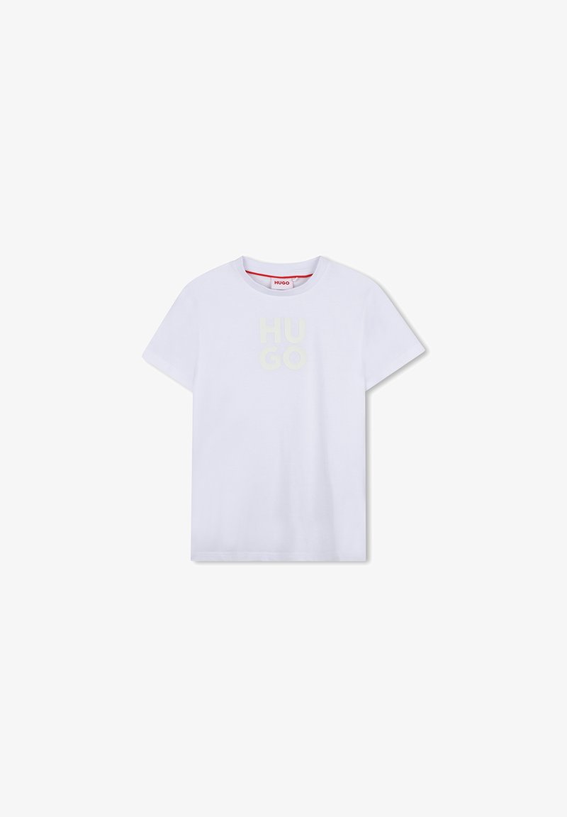 T-shirt en coton blanc à manches courtes, présentant un logo "HUGO" en jaune clair, doux et légèrement en relief, sur le devant.