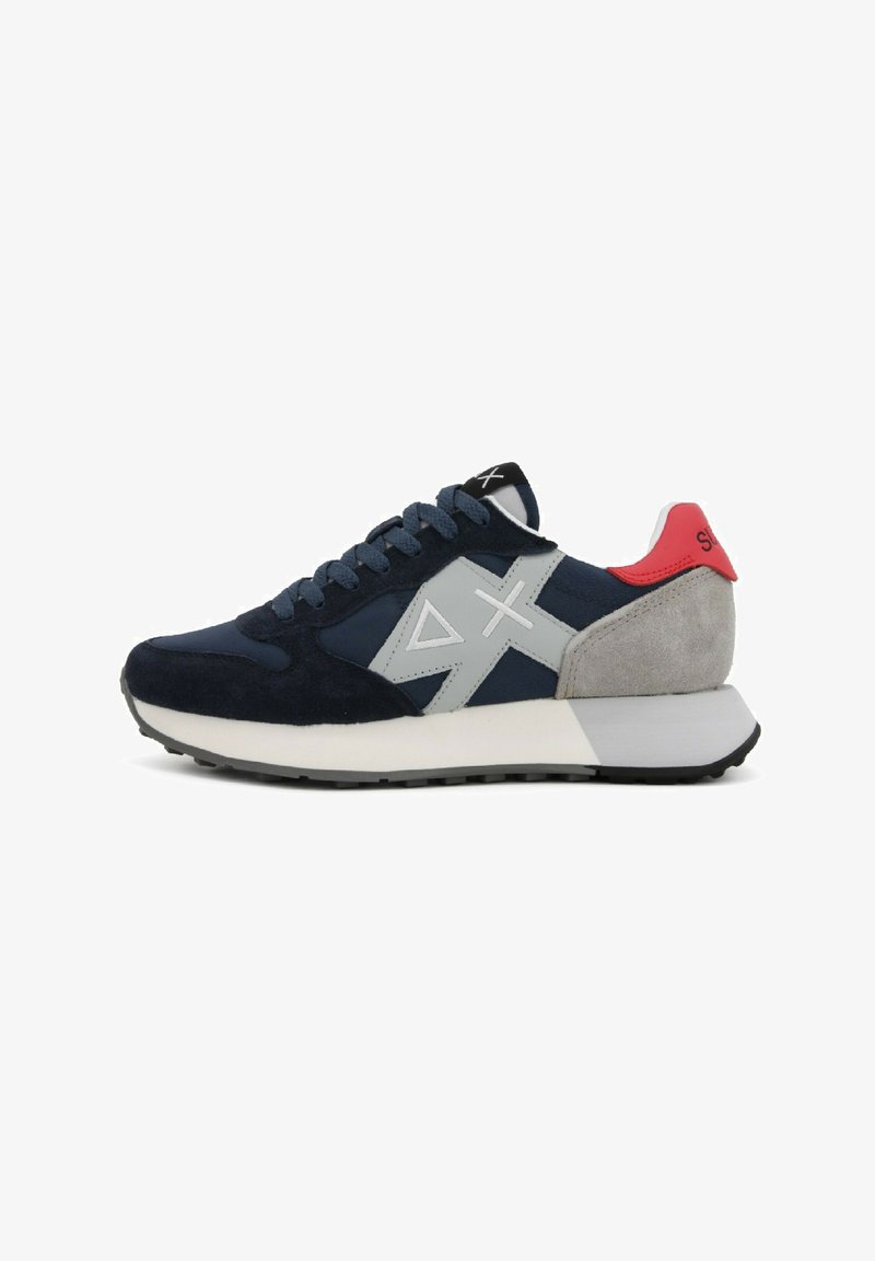 Navy suede sneakers with gray accents and red heel tab. Features a textured fabric upper, round toe, and contrasting midsole. Rubber outsole.
