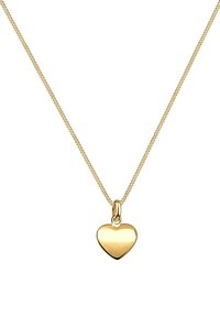 Collar de oro con una cadena delicada, que presenta un colgante pulido en forma de corazón. El colgante tiene una superficie lisa y un acabado brillante.