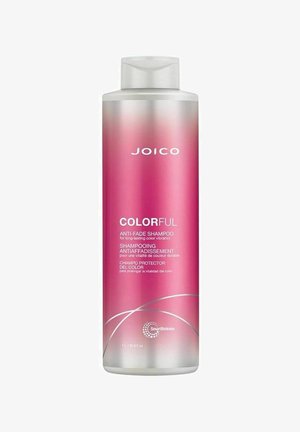 Vaaleanpunainen muovinen pullo JOICO Colorful -värejä säilyttävää shampoota, jossa on valkoinen käännettävä kansi ja hopeiset yksityiskohdat. Etiketissä on tekstiä useilla kielillä.
