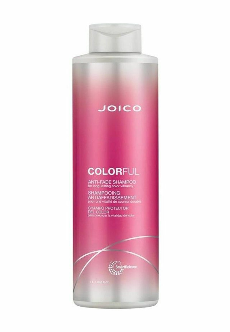 Vaaleanpunainen muovinen pullo JOICO Colorful -värejä säilyttävää shampoota, jossa on valkoinen käännettävä kansi ja hopeiset yksityiskohdat. Etiketissä on tekstiä useilla kielillä.